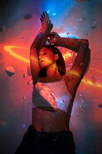A young woman immersed in a universe projection, enveloped by surreal landscapes, cosmic energy, and ethereal dreamscapes