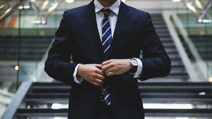 An image of an anonymous capitalist getting ready to conduct financial transactions
