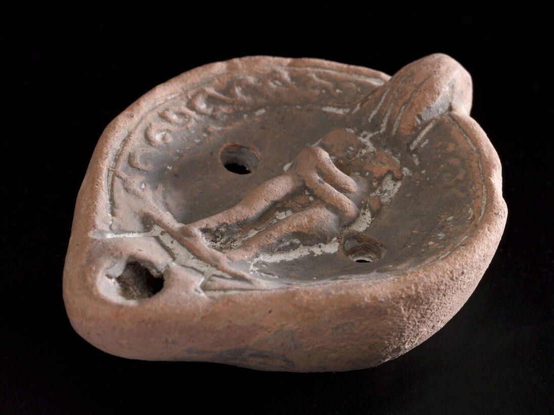 Terracotta lamp with lug handle and moulded design, Courtesy of Science Museum / Science and Society Picture Library