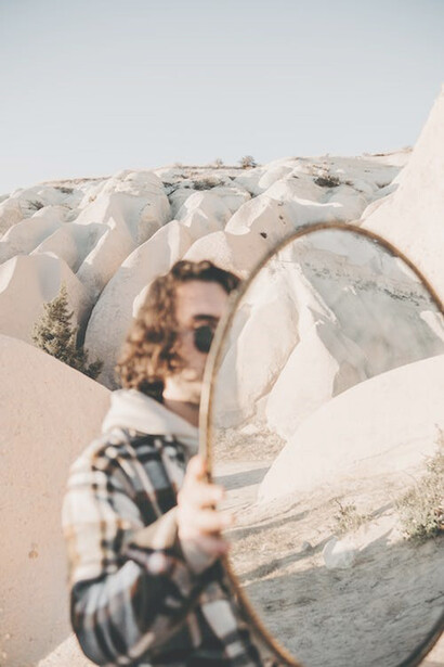 In the desert, a man with a mirror highlighted the interconnectedness of different realities, uniting earth and sky