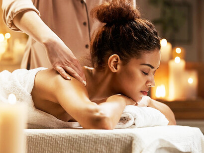 In the tranquil environment of an Ayurvedic spa, a woman receives a healing massage that aims to cleanse and rejuvenate her body, in line with ancient practices