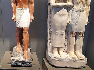 Polychrome limestone statues of an Old Kingdom noble and a standing couple statue on display at the Egyptian Museum in Cairo, Egypt