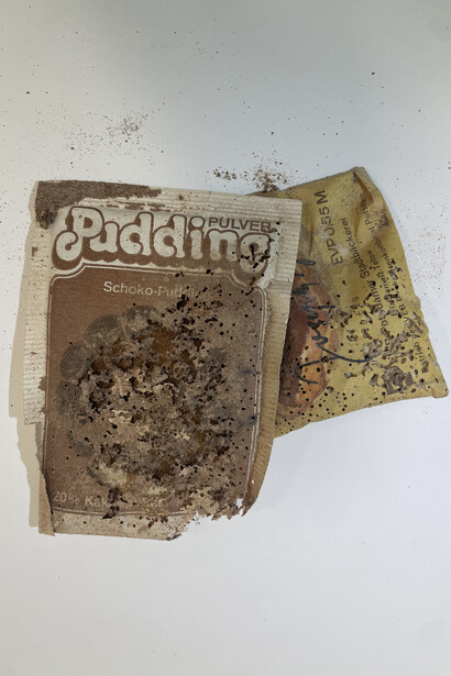 Current condition of heavily damaged chocolate pudding packaging that can no longer be exhibited. Courtesy of S.M.A.K