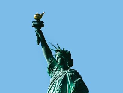 The Statue of Liberty in New York City under a clear blue sky, USA
