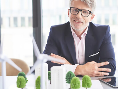 Amidst society's demands and global crises, a busy businessman ponders solutions to bolster ecological sustainability, highlighting the pressing need for action