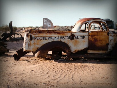 Disposed and rusted car in open space
