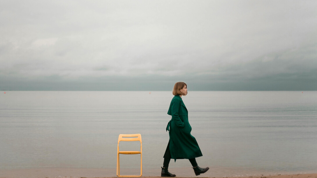 A person walking alone along the seashore
