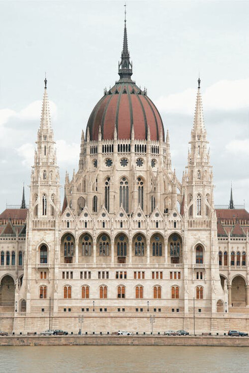 The Hungarian Parliament Building in Budapest, Hungary, a masterpiece of intricate design and detail, standing as a grand testament to Budapest’s rich history and architectural prowess