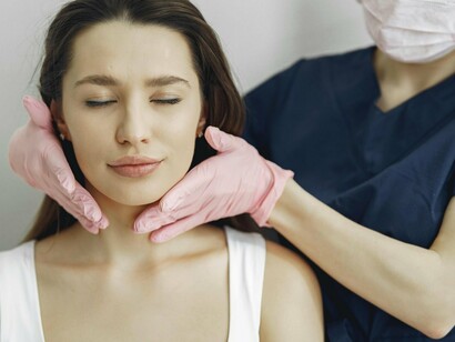 A woman undergoing aesthetic alterations, representing the hand-off between uniqueness and conformity