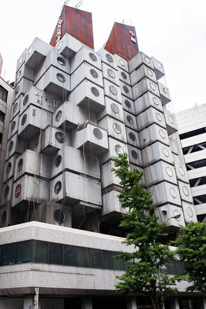 The exterior of the Nakagin Capsule Tower in Tokyo, Japan, showcasing its distinctive capsule apartments