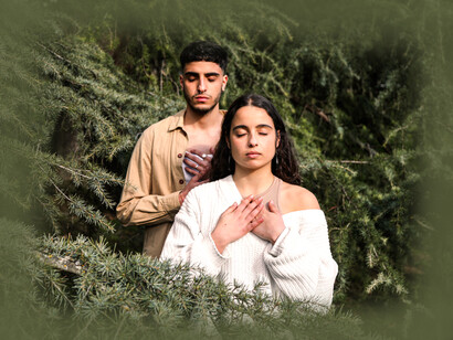 A man and a woman practicing consciousness in the trees