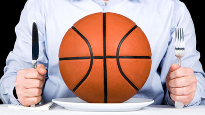 A man with a knife and fork, and a basketball