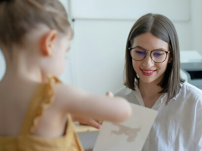 While exploring a world of new toys, a mother and her child share a delightful moment of communication and language development