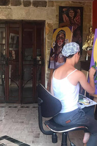 Nik Keter works on a painting in the series titled 'In the Name of the Mother and the Daughter'