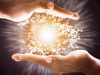 Hands holding energy; energy is governed by the principle of conservation
