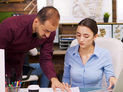 A female architect designing 3D building models using Building Information Modeling (BIM) and incorporating 3D printing technology in construction