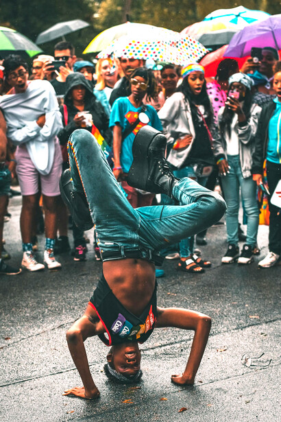 Dancer moving gracefully in the rain, embodying freedom and protest