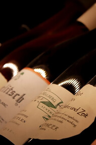 White labeled wine bottles on brown wooden table