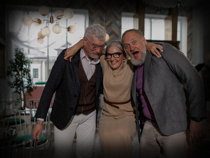 Three older people laugh and have fun together
