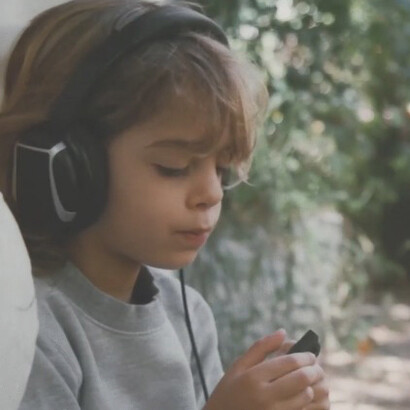 Director Ana Petta with her children, Maria and Pedro, at their home in São Paulo — scenes from Amora, a documentary that explores memory, childhood, and urban transformation