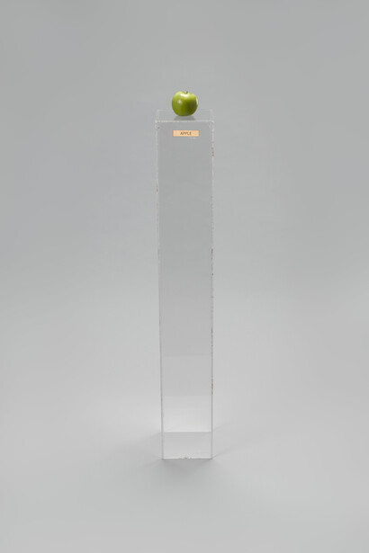 Yoko Ono (Japanese, born 1933), Apple. 1966. Plexiglas pedestal, brass plaque, apple, 45 × 6 11/16 × 6 15/16″ (114.3 × 17 × 17.6 cm). Private collection. © Yoko Ono 2014