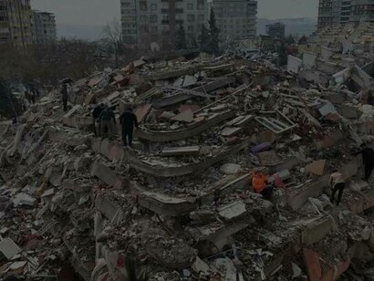 Rescuers and civilians look for survivors under the rubble of collapsed buildings in Kahramanmaras, Turkey, close to the quake's epicenter