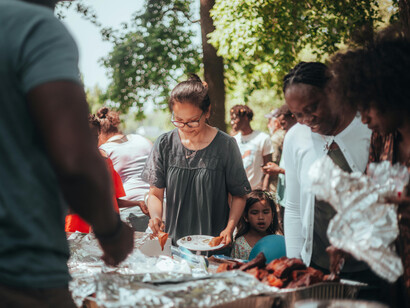 People gathered in a park for a social event, illustrating community gathering, people coming together, human connection, and group unity