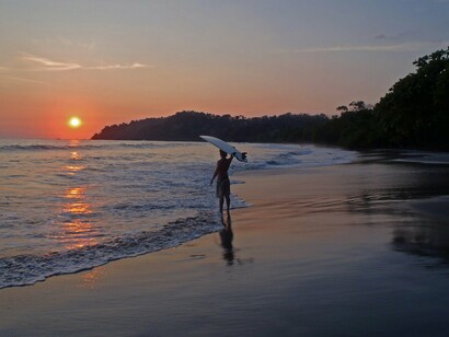 Surfing at dusk in Costa Rica blends adventure with serenity