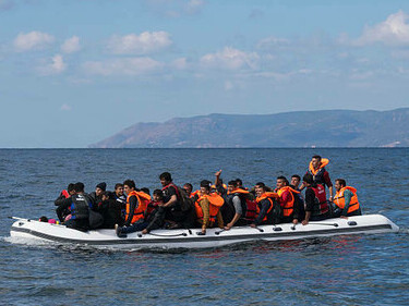 A refugee boat arriving on the shores of Lesbos, Greece, symbolizing the ongoing migration crisis