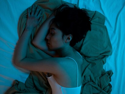 A woman sleeping with hand on head feeling the grief