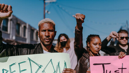 In the midst of a chaotic protest, people converge with a shared sense of urgency, reflecting a collective frustration that often overrides individual critical thinking