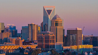 A skyline dominated by corporate giants symbolises our current path of unsustainable growth and inequality, where global decisions echo in boardrooms rather than communities