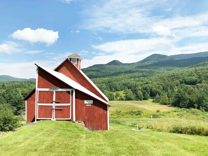A classic red barn isolated in the hills of Stowe, Vermont. Photo by Jamie Edwards