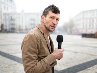 A reporter on the street preparing to conduct a news interview
