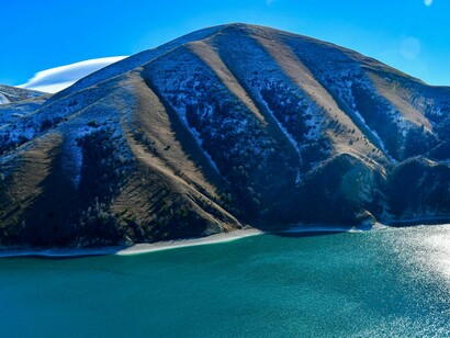 A picturesque view of Lake Kezenoy-am, surrounded by towering mountains, has made it a popular destination for anyone who enjoys nature