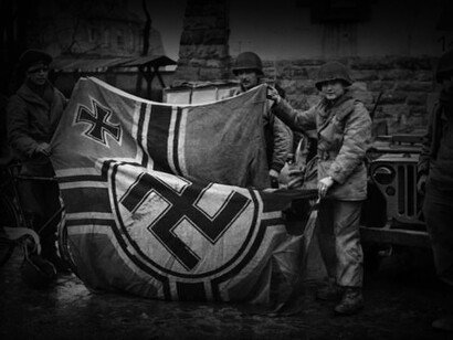 Soldados del Eje Aliado retiran una bandera nazi luego de la Batalla de Berlín en mayo de 1945