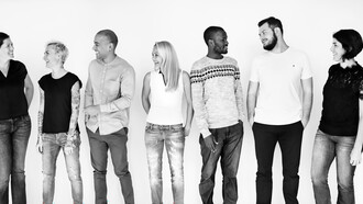 A diverse group of people enjoying themselves together, embodying the values of inclusivity and collaboration within a multicultural workforce