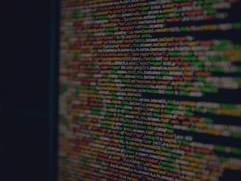 The visual landscape of colorful code on computer monitors, while contemplating the ethical implications and legal obligations surrounding chatbots and data privacy