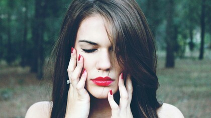 A woman who is an introvert is closing her eyes and concentrating