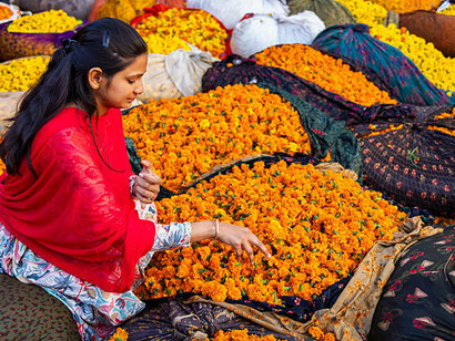 Flower sellers work amid the bustling crowds at KR Market in Bangalore, India