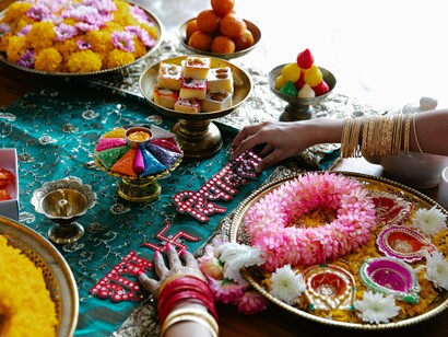 Women engaged in festive preparation, symbolising the joy and reverence of the Diwali rituals