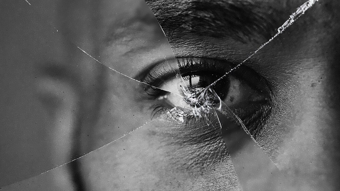 Eyes reflected in a shattered mirror, symbolizing critical thinking and the struggle between truth and illusion