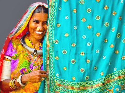Traditional costumes of Gujarat, with vibrantly coloured blouse and bangles, are worn by the women in Gandhi nu Gam
