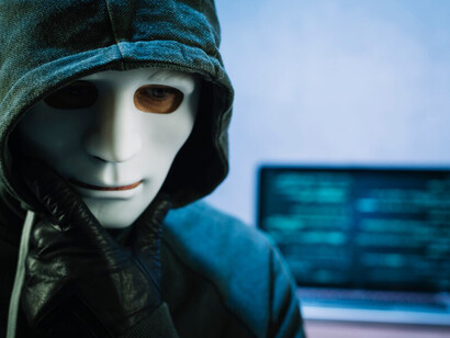 A hacker with a laptop highlights the critical issues of data privacy and data collection in today’s digital landscape