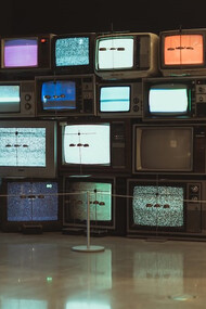Televisions placed on a brown wooden floor
