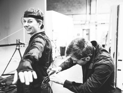 An actor is being equipped with technical garments and wires in order to shoot a crucial scene in an upcoming project