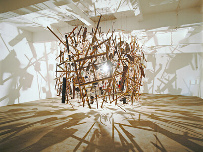 Cornelia Parker, Cold Dark Matter: An Exploded View, 1991, garden shed, explosion, wires, light. Cornelia Parker's iconic artwork, "Cold Dark Matter: An Exploded View" (1991), is a powerful installation that explores themes of destruction, transformation, and the hidden life of everyday objects. Parker had the British Army explode a garden shed, filling it with collected objects – some personal, some found, aiming for an archetypal representation of a shed and its contents. Photo: Hugo Glendinning/Courtesy Frith Gallery, © 1991 Cornelia Parker