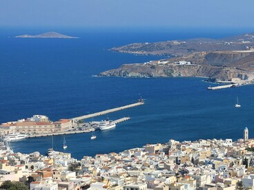 A scenic overlook of Ermoupoli, Syros, with the tranquil Aegean in the background, symbolizing why the island is celebrated as the cultural heart of the Cyclades