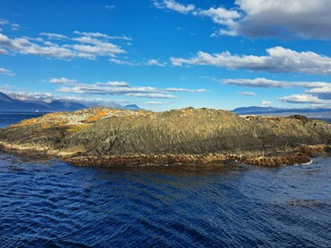 A rugged island surrounded by the Beagle Channel near Ushuaia, Argentina, representing the strategic waterways connecting the Atlantic and Pacific