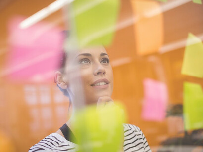 Female executive organizing and setting goals with sticky notes